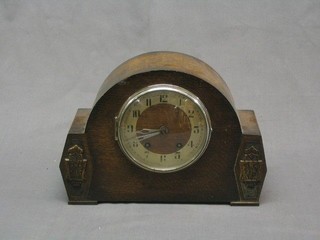 A 1930's 8 day striking mantel clock contained in an oak arched case by Brevingtons 5-10