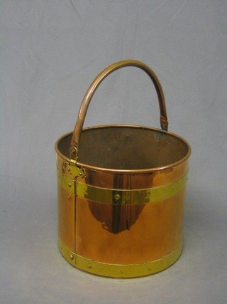 A circular copper and brass coal bucket