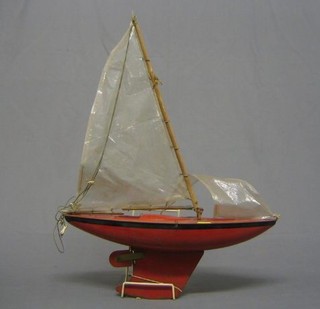 A red painted Triang metal pond yacht