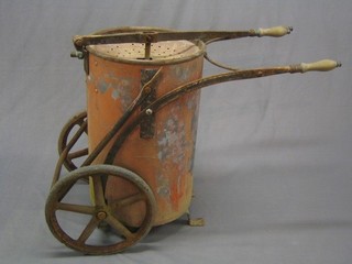 A 19th/20th Century steel, copper and iron portable fire pump, raised on iron wheels