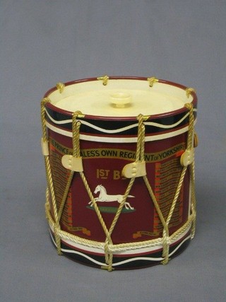 A circular plastic ice bucket in the form of a side drum for the First Battalion The Prince of Wales Own Regiment of Yorkshire complete with battle honours