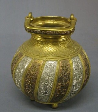A circular Eastern bronze and gilt Cauldron with swing handle, raised on 4 bun feet 8"