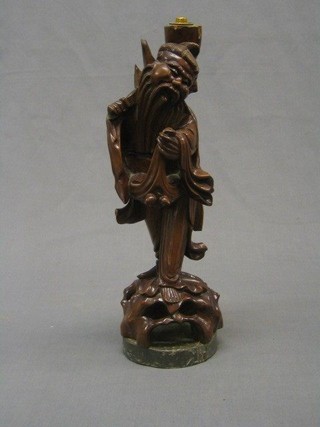 An Oriental carved rootwood table lamp in the form of a standing Deity 15"