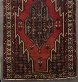 A contemporary tan ground Persian carpet with central medallion within multi-row borders 77" x 50"