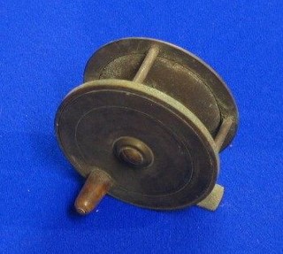 A brass centre pin fishing reel marked Murton of Newcastle 3"