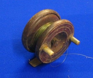 A wooden and brass star back centre pin fishing reel 3"