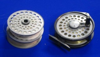 An aluminium centre pin fly reel 3 1/2" and 2 spare spools