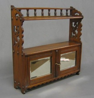 A Victorian walnut hanging shelf/cabinet, the upper section with bobbin decoration, the base fitted a cabinet enclosed by a bevelled plate panelled door 24"