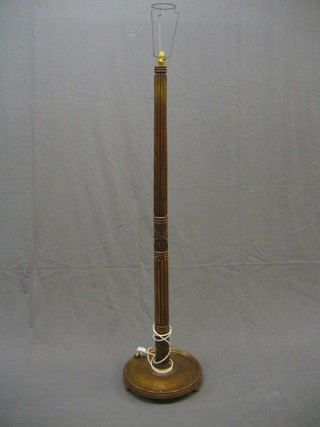 A turned and reeded mahogany standard lamp