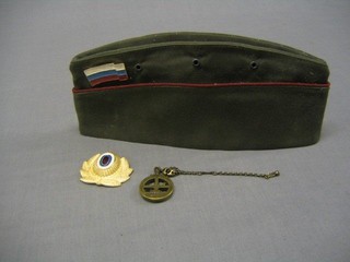A modern Soviet Russian side cap, a cap badge and a key ring