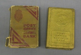 A 1935 metal Post Office savings money box in the form of a book contained in a cardboard sheath