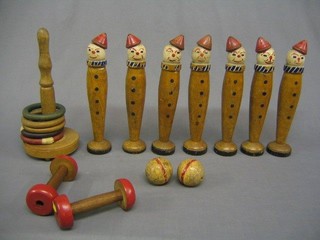 7 20th Century turned wooden skittles in the form of clowns, a coits game, 2 dumb bells and 2 balls