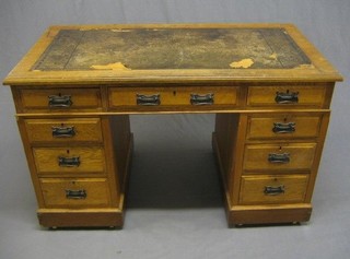 A Victorian Arts & Crafts movement honey oak kneehole pedestal desk with inset tooled leather writing surface above 9 drawers, 48"