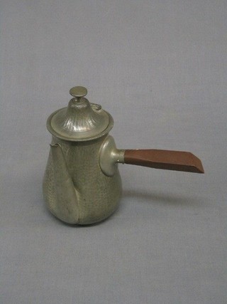 An Art Deco planished lion pewter  side handled coffee pot