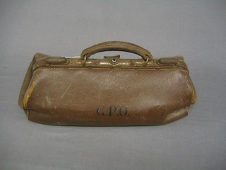 An old leather Gladstone bag marked GPO