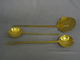 A pierced brass cream skimmer and 2 brass "range" spoons