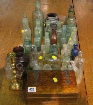 A small oak writing slope with Art Nouveau pierced metal hinges 8 1/2" and a collection of glass bottles