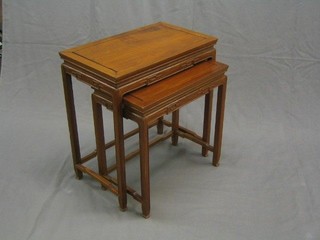 A nest of 2 Oriental Padouk wood coffee tables 24" (moulding missing to the side)