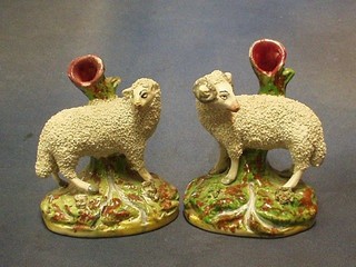 A pair of 19th Century Staffordshire spill vases in the form of figures of sheep, 5" (f and r)