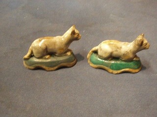 A pair of 18th/19th Century Staffordshire figures of seated cats raised on green oval bases 3 1/2"