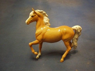 A Beswick figure of a standing Palomino horse (tail f and r)