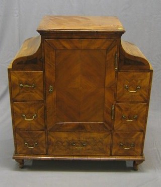 An 18th Century Dutch marquetry table top cabinet, the centre section fitted a cupboard enclosed by panelled door, flanked by 6 short drawers with a long drawer to base, raised on cabriole supports 37"