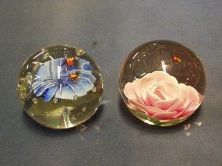 2 glass paperweights, the interiors decorated flowers and bees