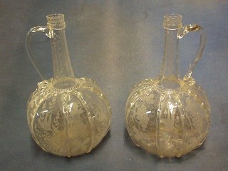 A pair of 18th Century "Dutch" etched glass bottle shaped jugs 10"