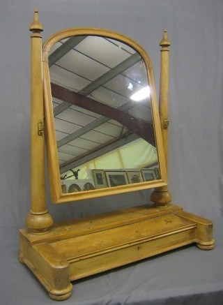 A Victorian arched plate dressing table mirror contained in a stripped pine swing frame, the base fitted a drawer 29"