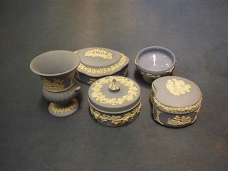 A circular blue Jasperware jar and cover, base marked 75 3", an oval trinket box 4" base marked 74, an urn of campanular form marked 72 4", a kidney shaped trinket box marked 69 3" and a small circular dish marked 57 chip to base 3"
