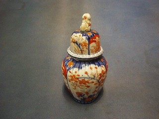 A 19th Century Japanese Imari porcelain urn and cover the finial in the form of a seated dog of fo (slight chip) 8"