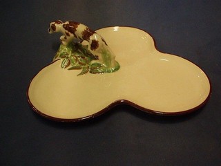 A Wedgwood white glazed pottery trefoil shaped dish, the handle in the form of a hound, the base impressed Wedgwood 11"