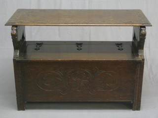 A carved oak monks bench with hinged lid 42"