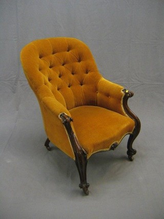 A Victorian mahogany show frame tub back chair upholstered in mustard coloured material, on French cabriole supports