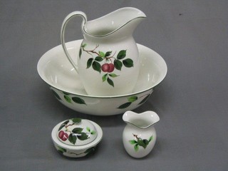 A Newport Pottery jug and bowl set complete with soap dish and tooth brush holder painted by T Butler