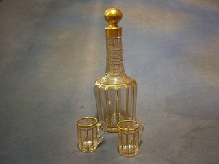 A 19th Century Bohemian panel cut and gilt decorated liqueur set comprising 2 decanters and 10 miniature mugs