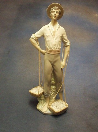 A Lladro figure of a standing fisherman with basket of fish, base marked Lladro and impressed M 9, 16"