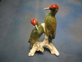 A 20th Century Continental porcelain figure group of 2 red headed woodpeckers 12"