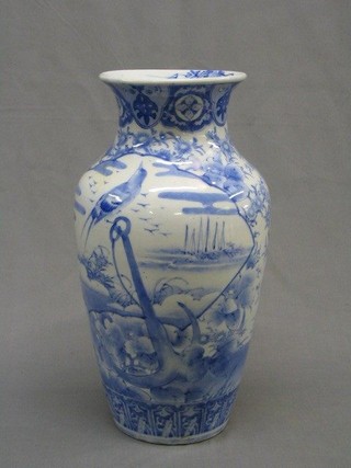An Oriental blue and white pottery baluster shaped vase 15"