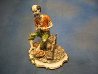 A Capo di Monte style figure of a seated fisherman 12"