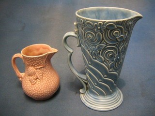 A pink glazed Wade jug 5" and a blue glazed Wade jug 9" (chip to rim)