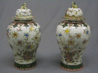 A large pair of  reproduction 19th Century Canton famille vert porcelain urns and covers 24"