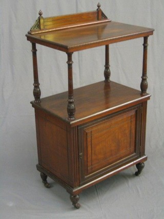 A Victorian walnut 2 tier what-not, the base fitted a cupboard enclosed by a panelled door, raised on turned supports 24"