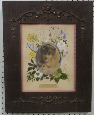An early black white portrait photograph of a lady 4" oval contained in a watercolour mount with floral decoration  contained within a carved frame
