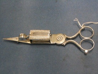 A pair of 19th Century silver plated patented wick trimming scissors with armorial decoration