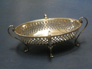 A pierced oval silver dish raised on 4 scroll supports London 1914 by the Goldsmiths and Silversmiths Co. 6", 4 ozs