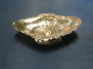 An 18th Century Continental embossed silver boat shaped boat, raised on a spreading foot 6 1/2", 3 ozs