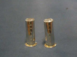 A modern plain silver salt and peppers in the form of 12 bore shot gun cartridges, makers mark PJBL