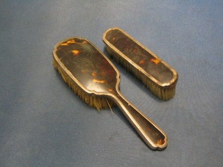 An Art Deco silver and tortoiseshell 2 piece dressing table set with clothes brush and hair brush, London 1933 and 1934