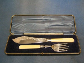 A pair of Victorian engraved silver fish servers, Sheffield 1896, cased